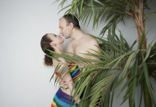 young couple under a palm tree in the Studio