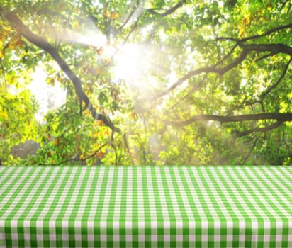 Empty table and defocused forest dawn inbackground