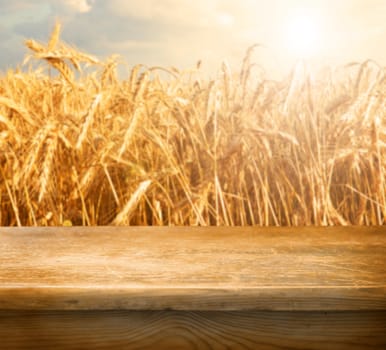 Empty table and defocused wheat field inbackground