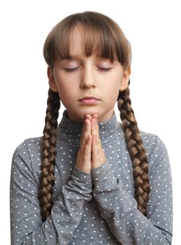 Beautiful little girl praying - closeup, isolated