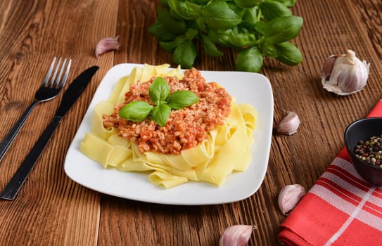 tagliatelle with cheese sauce garnished with basil leaves