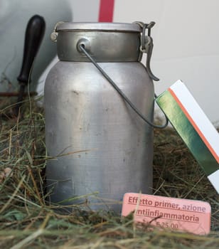 View of old iron milk can on the grass