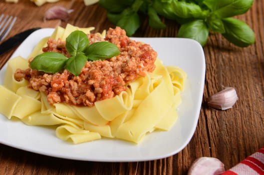 tagliatelle with cheese sauce garnished with basil leaves