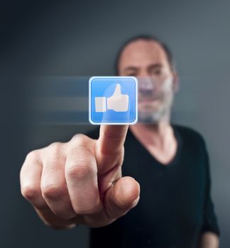 Close-up of man touching a social network icon (shot on PhaseOne 45)