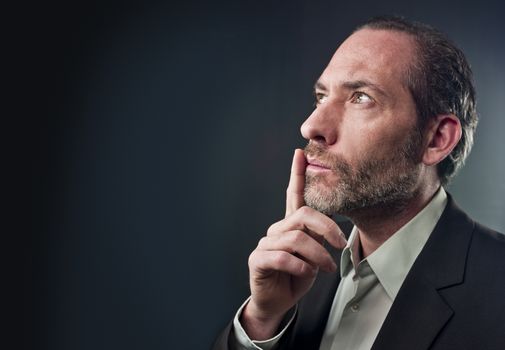 Studio shot of businessman in a deep thought over colored background (shot on PhaseOne 45)