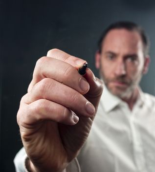 Close-up of mature business man writing with a ballpoint pen (shot on PhaseOne 45)