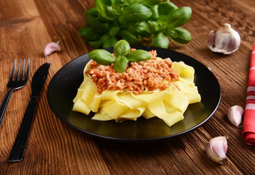 tagliatelle with cheese sauce garnished with basil leaves