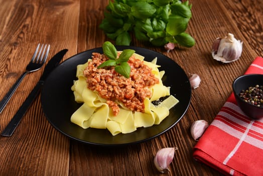 tagliatelle with cheese sauce garnished with basil leaves