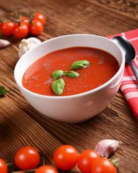 Tasty tomato soup on wooden background