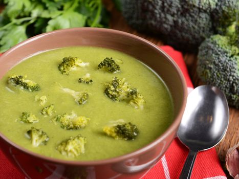 Tasty broccoli soup on wooden background