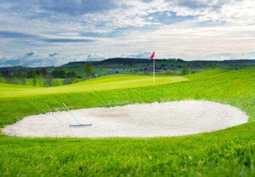 a putting green with flag - evening sun