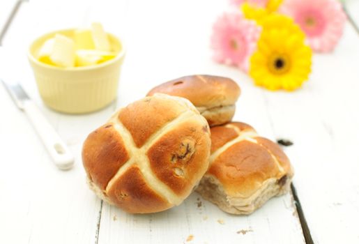 Freshly baked hot cross buns on a kitchen table
