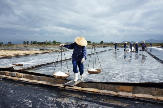 BA RIA, VIET NAM- FEBRUARY 3: Salt worker working on salina,they harvesting white salt in  Ba Ria, Viet Nam on February 4, 2013