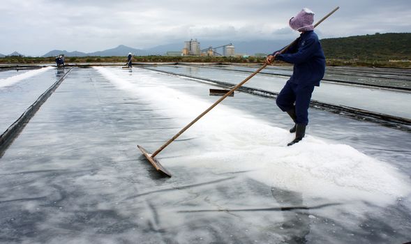 BA RIA, VIET NAM- FEBRUARY 3: Salt worker working on salina,they harvesting white salt in  Ba Ria, Viet Nam on February 4, 2013