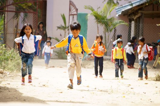 KHANH HOA, VIET NAM- FEBRUARY 5: Chidren in school is outat countryside, they don't wear uniform, jump around out school, Khanh Hoa, Viet Nam, February 5, 2013          