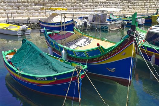 Traditional Maltese luzzu boats moored in the harbour - St Paul's Bay, San Pawl il-Baħar, Malta