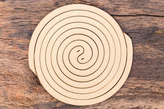 Mosquito coil is insect repellent and mosquitoes on wood background