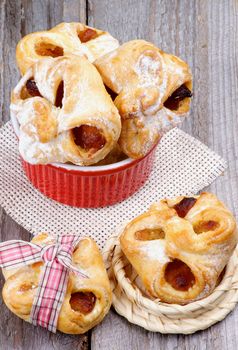 Arrangement of Homemade Pastry Baskets Jam Wrapped with Sugar Powder in Various Bowls closeup on Rustic Wooden background