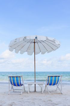 Beach Chair and white umbrella against the sea