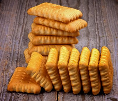 Two Heaps of Crunchy Butter Biscuits closeup on Rustic Wooden background