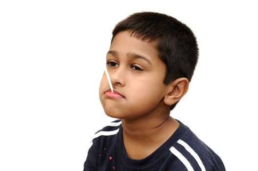 an handsome Indian kid having dun savoring a lollypop