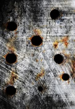 Old silver metal plate with bullet holes