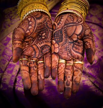 beautifully decorated indian hands with mehandi typically done for weddings