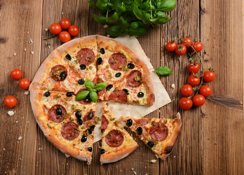 Tasty pizza with olives and salami