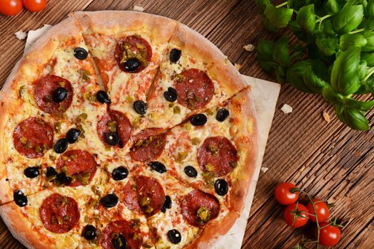 Tasty pizza with olives and salami