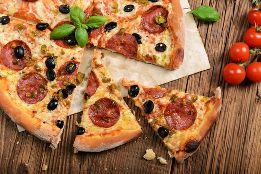 Tasty pizza with olives and salami