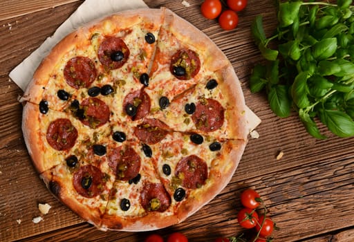 Tasty pizza with olives and salami