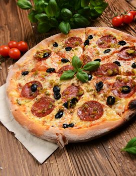 Tasty pizza with olives and salami