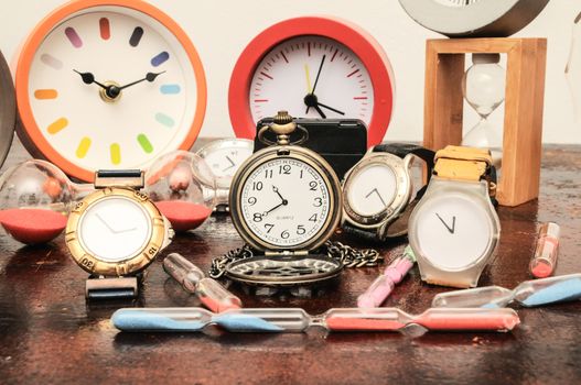 Many Different Clocks on a Woden Table