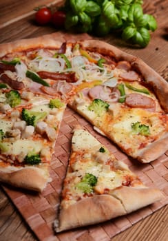 Tasty pizza with broccoli on old wooden background