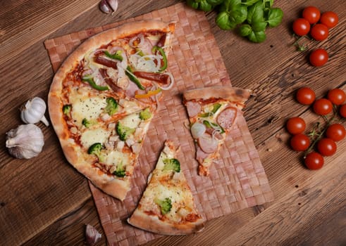 Tasty pizza with broccoli on old wooden background
