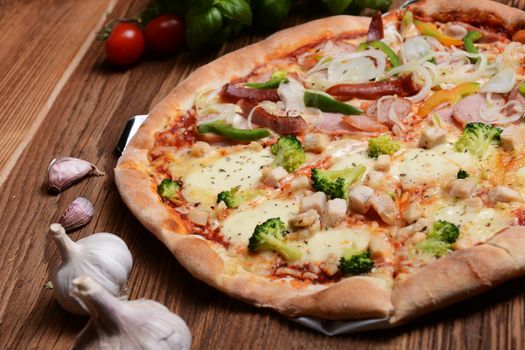 Tasty pizza with broccoli on old wooden background