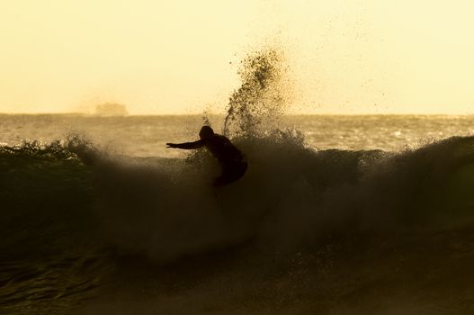 Backlight Silhouette Surfer in the Ocean at Sunset