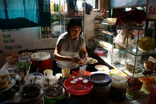 DA LAT, VIET NAM- DEC 28: Vietnamese  restaurateur serve dish at sweet soup reataurant in Dalat, Vietnam on Dec 28, 2013
