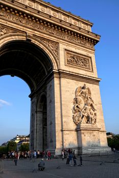 A fragment of Arc de Triumph in Paris, on a blue sky