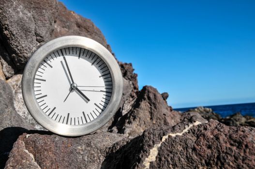 Time Concept Alarm Clock on the Volcanic Rocks