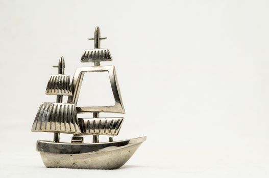 Metal Sailing Boat Figurine on a white background