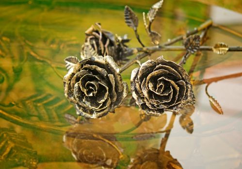 Three pretty shiny Golden rose, forged from metal. Manual work.