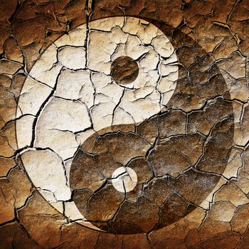 The Ying Yang sign painted on cracked earth 