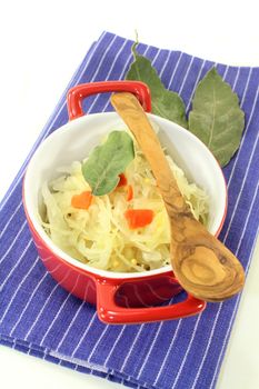 fresh cabbage with carrots and bay leaf