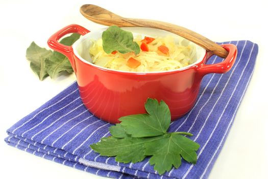 fresh cabbage with carrots and bay leaf