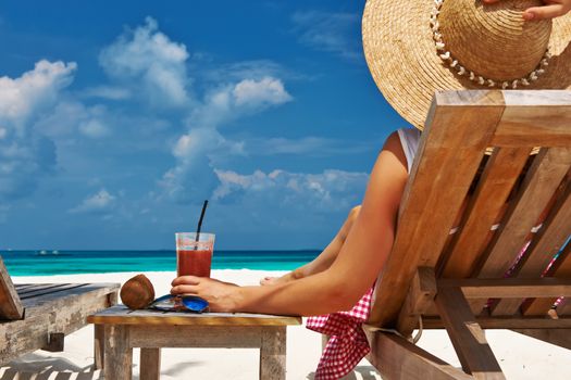 Woman at beautiful beach with chaise-lounges