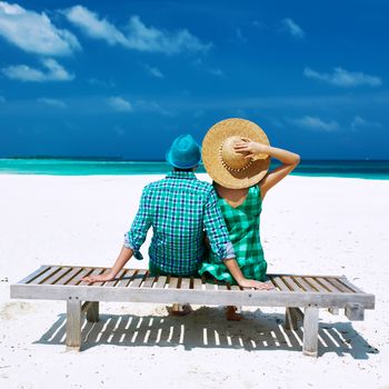 Couple in green on a tropical beach at Maldives