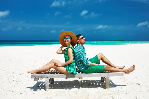 Couple in green on a tropical beach at Maldives