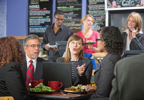 A Female executive explaining her plans at a bistro