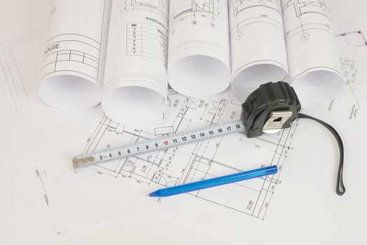 Construction drawings, tape measure and pen. Desk builder